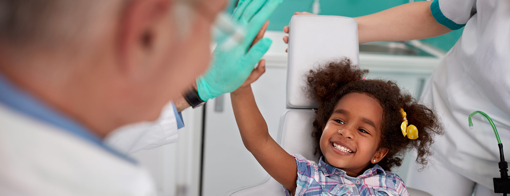 young girl giving her dentist a high five